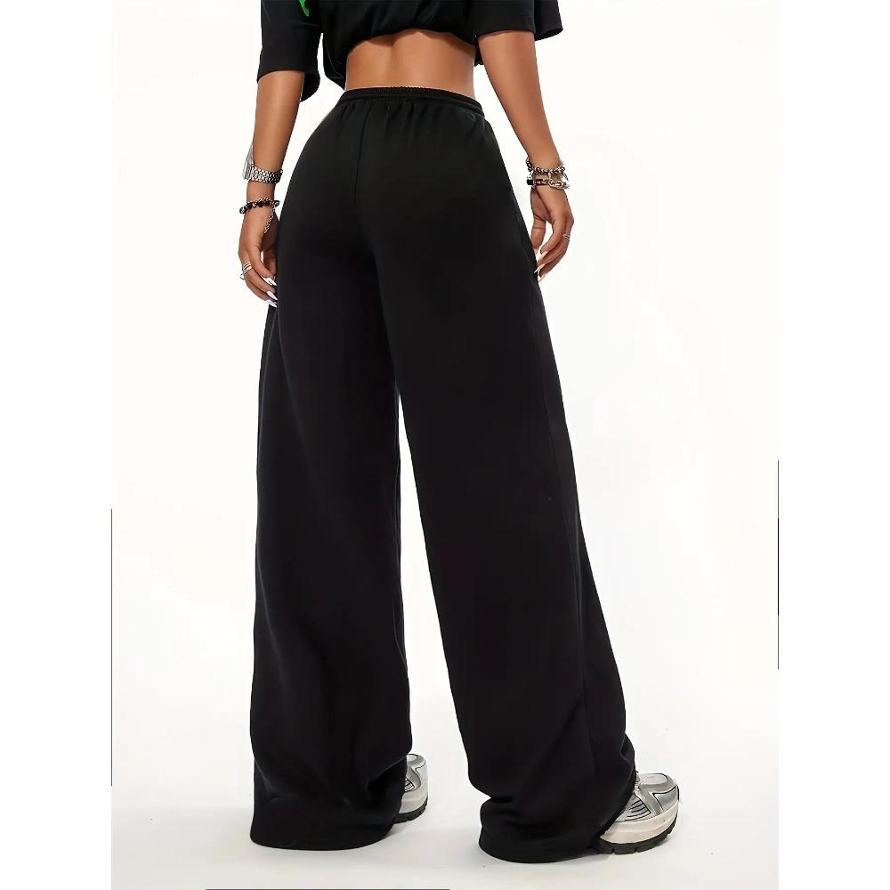 Women's black and pink jogging pants with a cherry blossom print inspired by Japanese floral designs