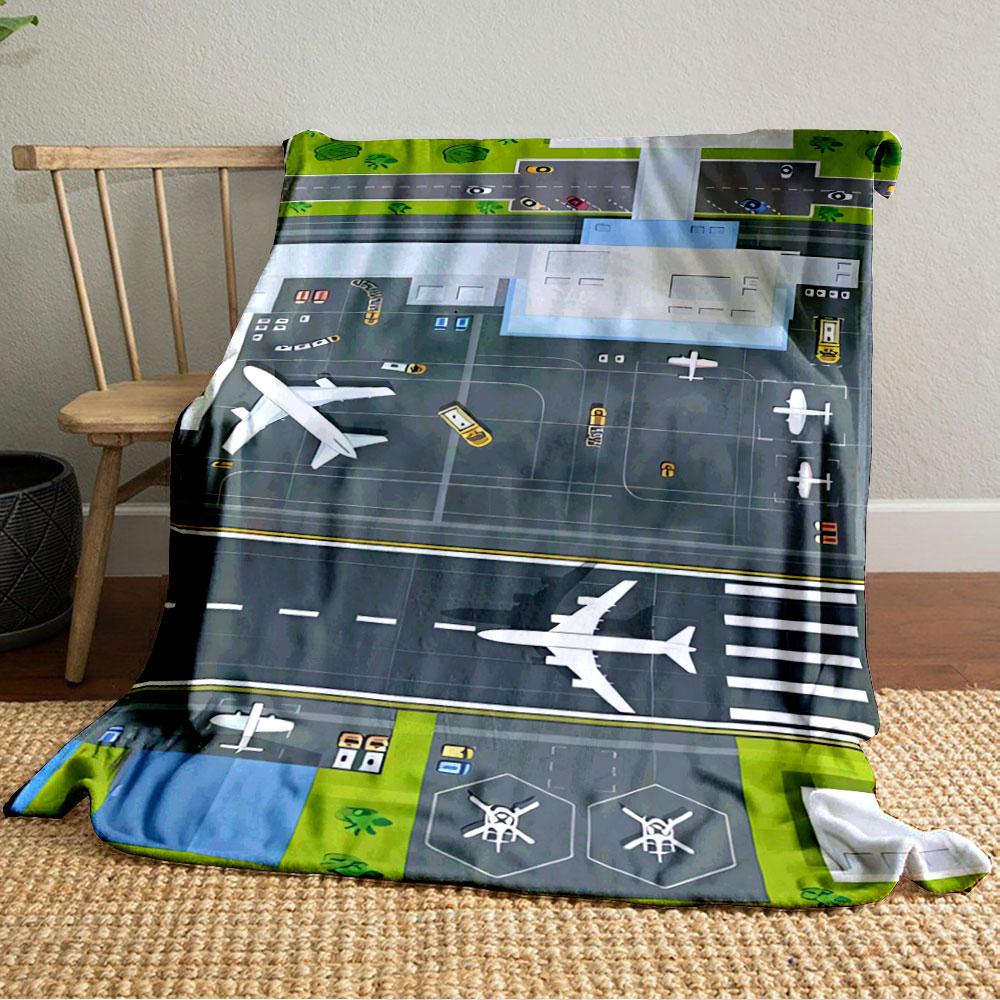 An aerial view of an airport layout with planes, runway, and vehicles. for all seasons blanket lunch break throw gift