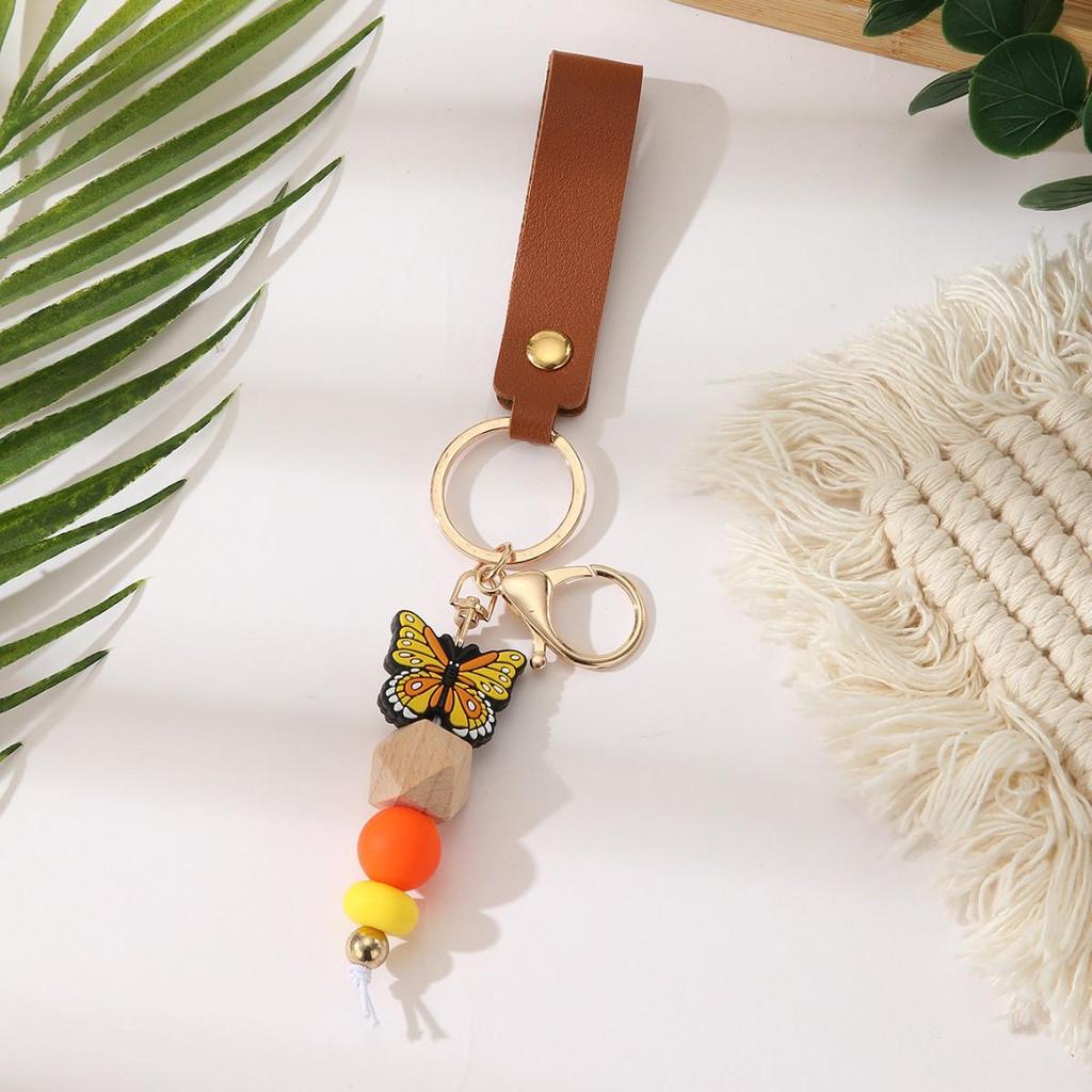 European & American Sweet Butterfly Daisy Silicone Beaded Keychain with Leather Bow Pendant