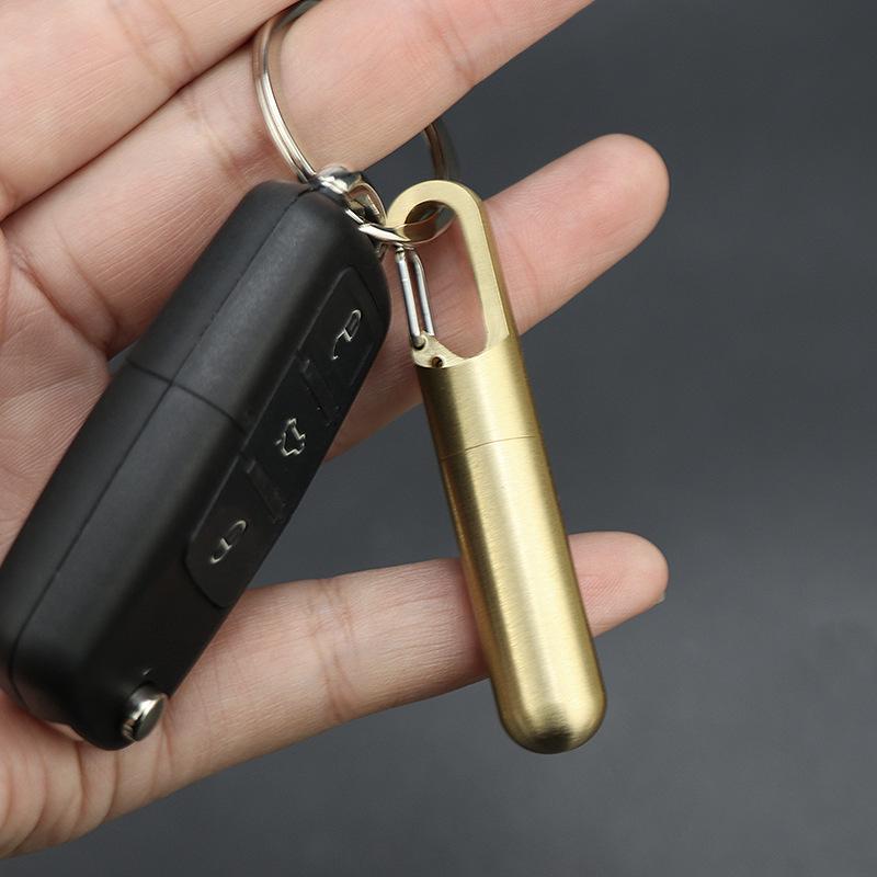 Compact Brass Pill Bottle: Waterproof, Dustproof, Moisture-Proof Storage Jar with Key Hook - Ideal for Travel or Everyday Use.