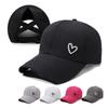 A Solid-color Heart-shaped Baseball Cap with an Adjustable Snapback Strap, Designed To Be Worn with a High Ponytail Tied Across the Back