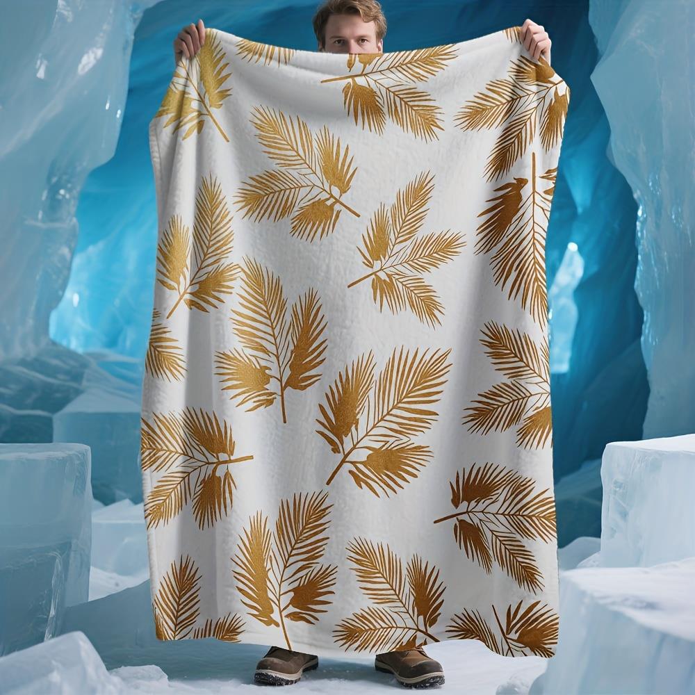 

A shimmering gold palm leaf patterned blanket in polyester fabric machine washable suitable for bedroom and living room décor 75x100cm