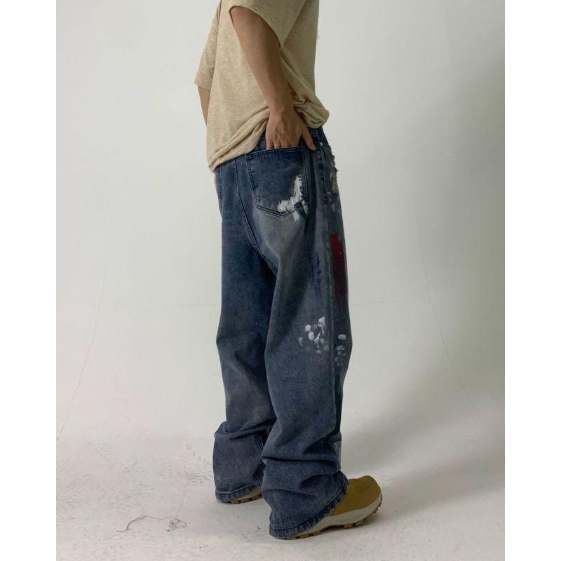 Europejskie i amerykańskie dżinsy uliczne z plamami atramentu dla mężczyzn i kobiet niszowy design z dziurami luźne spodnie z szerokimi nogawkami dla par codzienne spodnie na wszystkie mecze