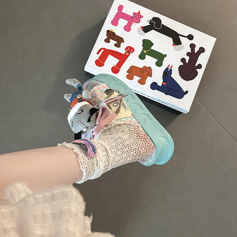 Cartoon doll thick-soled one-word slippers female summer design sense cute fringed beach shoes flat-soled semi-drag cool slippers