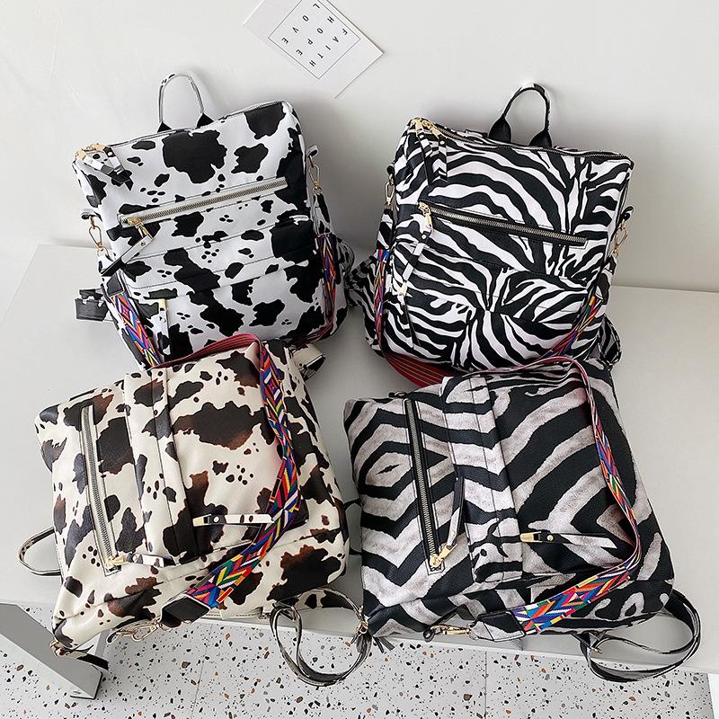 Neuer PU Retro Rucksack mit großer Kapazität für Reisen, Kuhmuster, schlichter britischer Stil, schräg über die Schulter tragbar, für Damen