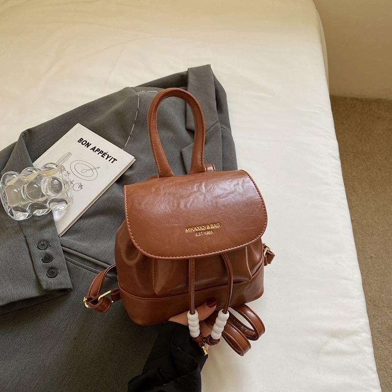 

Винтажный рюкзак в стиле колледжа для женщин 2025 осень новый корейская версия однотонный рюкзак иностранный стиль портативная сумка-ведро тренд коричневый