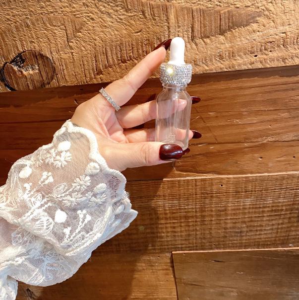 Diamond-Inlaid Frosted Glass Essential Oil Bottle with Rubber Dropper for Serums and Liquid Cosmetics.