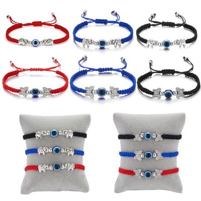 Verstellbares rotes Seilarmband mit bösem Blick und Schmetterlingsdesign