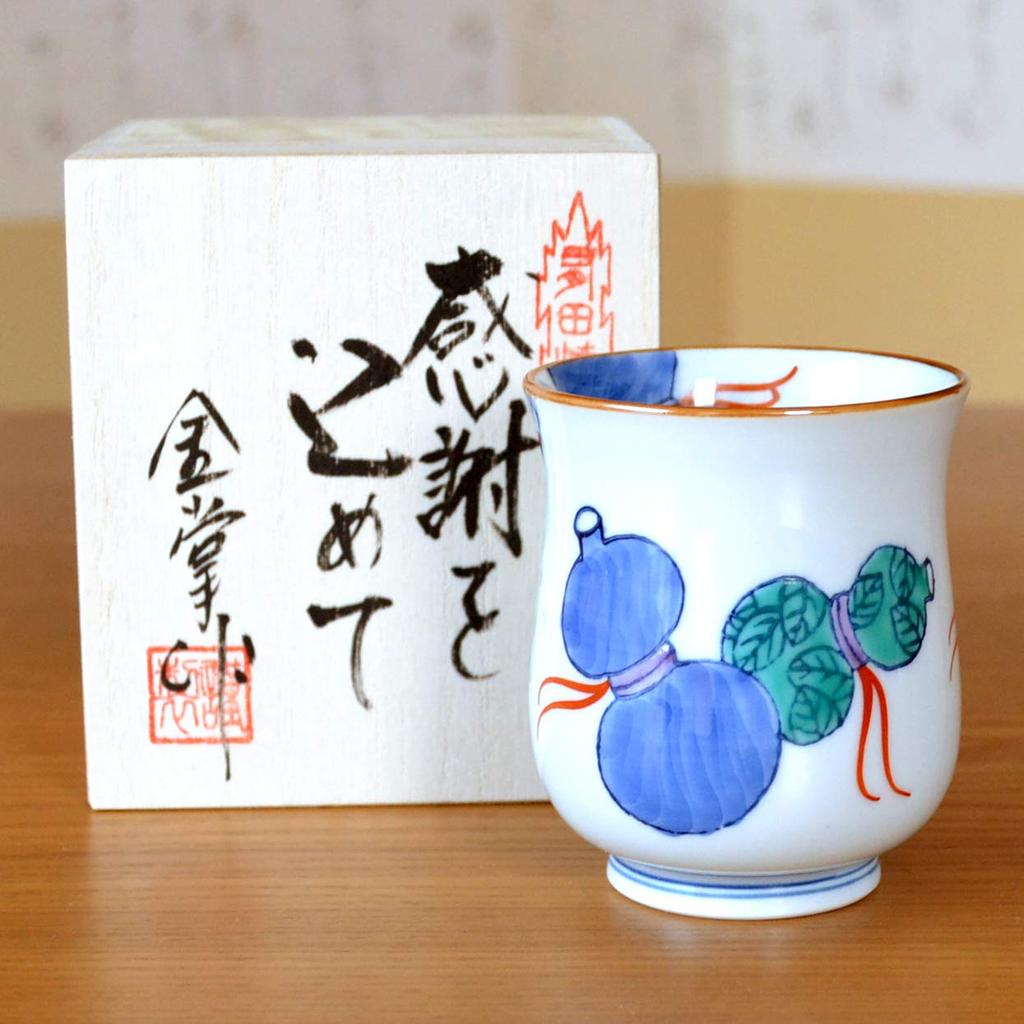 Auspicious gift for men celebrating wishing them good health and Arita ware Nabeshima Rokugyo presented in a wooden box with retirement, prosperity.