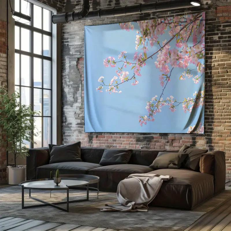 Pink cherry blossoms bloom on an indoor wall decoration tapestry against a blue sky background