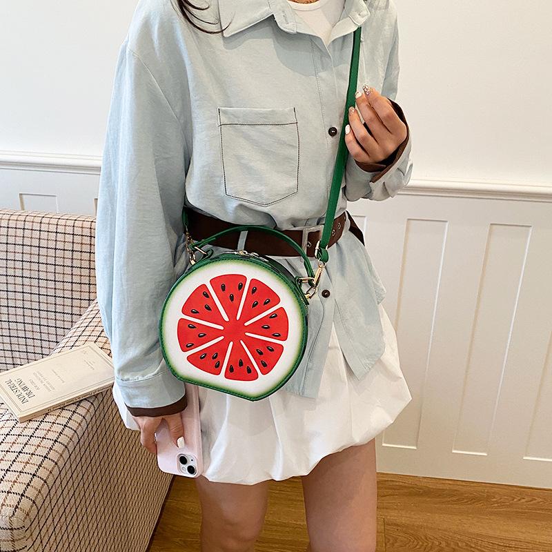 A Girl Carrying An Unconventional-shaped Bag Over Her Shoulder for Daily Commuting Purposes.