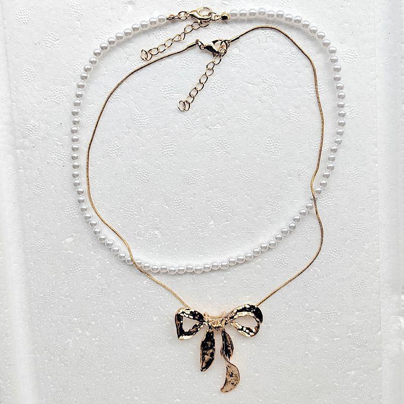 European & American Summer Fashion: Layered Alloy Bow Tie Necklace with Faux Pearl.