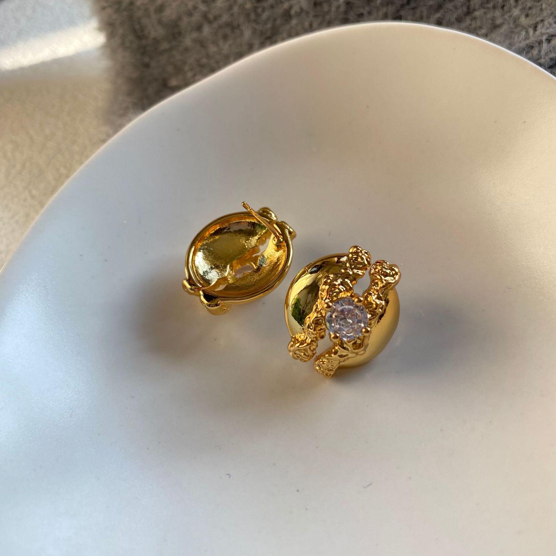 European and American cold wind metal European stud earrings pleated lava zircon design sense niche advanced round hollow stud earrings female
