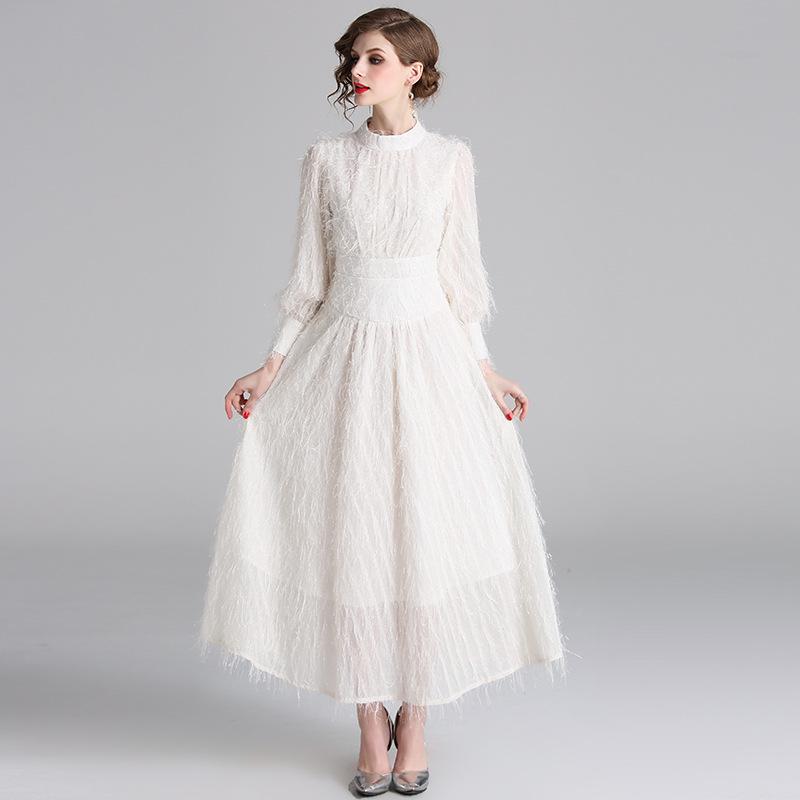 white dress with tassels on sleeves