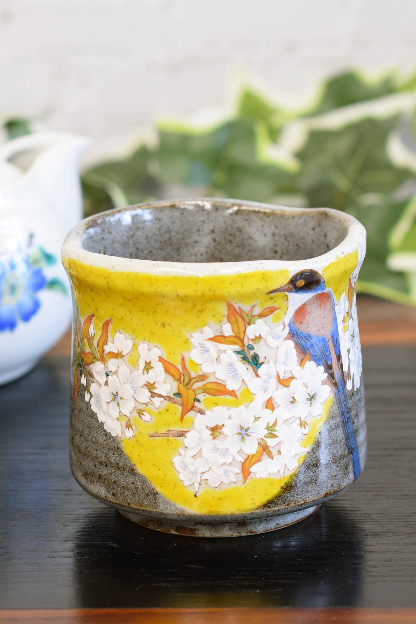 

Waza no Stylish Kutani ware teacup featuring Yoshidaya mountain cherry blossoms and a Large Japanese Kura bird. teacup/rice bowl. High-quality