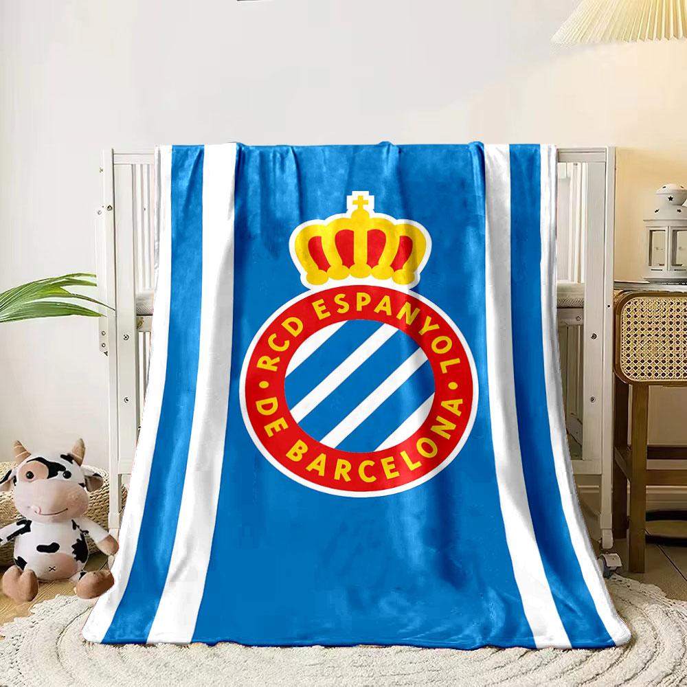 A blue background with white stripes and a crowned red circular emblem. for all seasons blanket lunch break throw gift