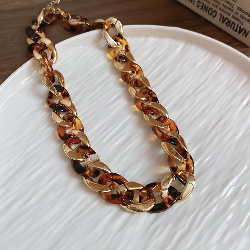 Meillard Leopard Print Jewelry Set: Interlocking Earrings, Necklace, Bracelet, and Ear Studs.