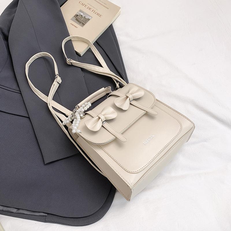 South Korea solid color college style commuter backpack women 2025 new trend bow portable shoulder messenger bag