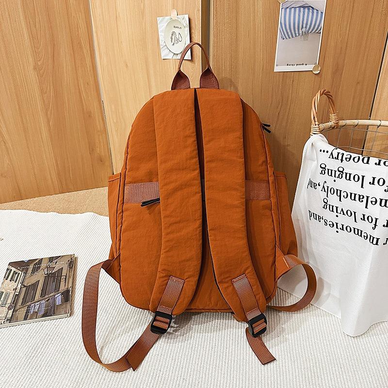 New high-value fresh and sweet backpack couple solid color simple mountaineering travel lightweight backpack