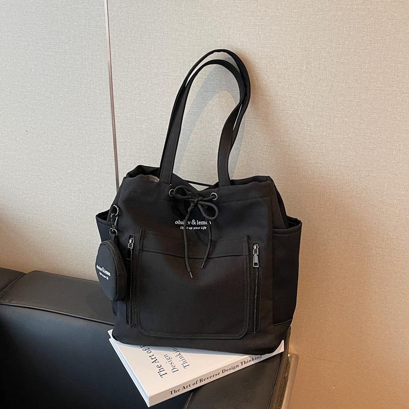 

Large capacity double pocket commuter canvas bag women 2025 new student class shoulder bag casual solid color tote bag чёрный
