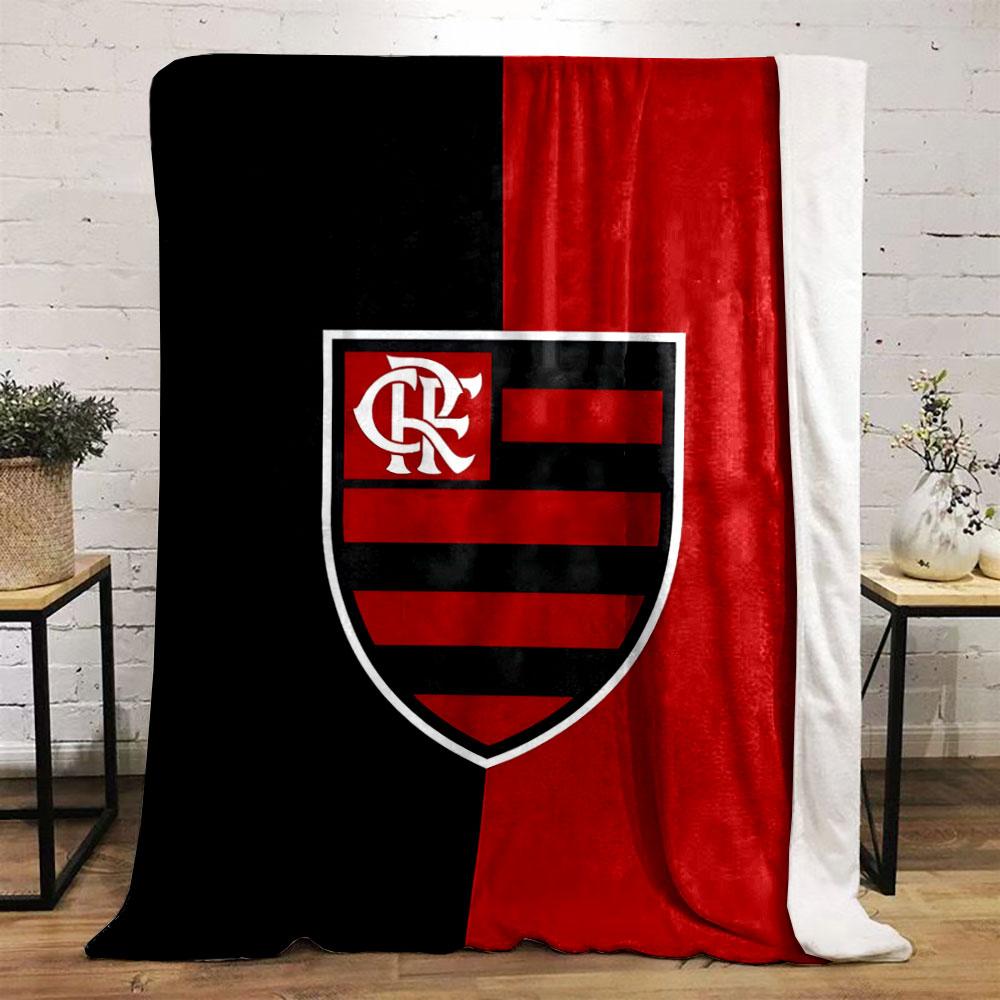 A vertically split black and red background with a striped shield emblem. for all seasons blanket lunch break throw gift