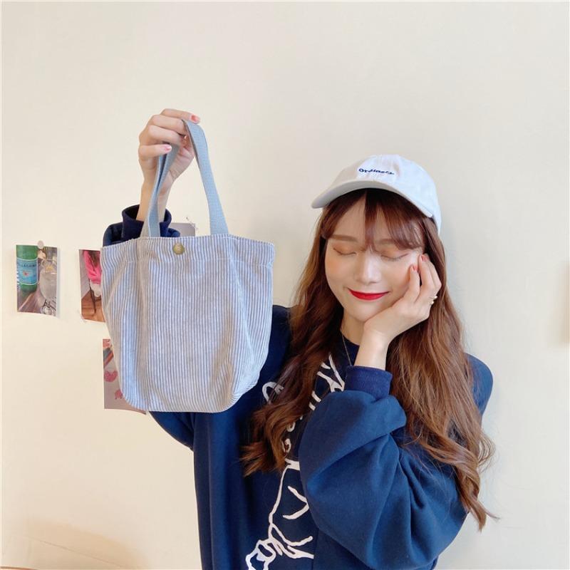 [Spot] Literary and artistic corduroy bag portable casual women's small hand bag retro cloth bag bento bag