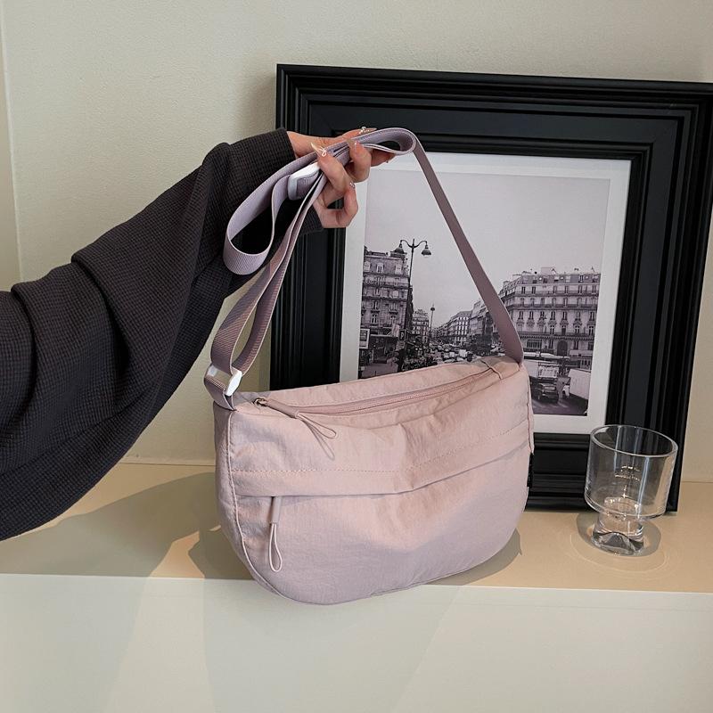 

Korean version of casual small bag women s 2025 new nylon cloth dumpling bag wide shoulder strap single shoulder messenger bag one piece delivery фиолетовый