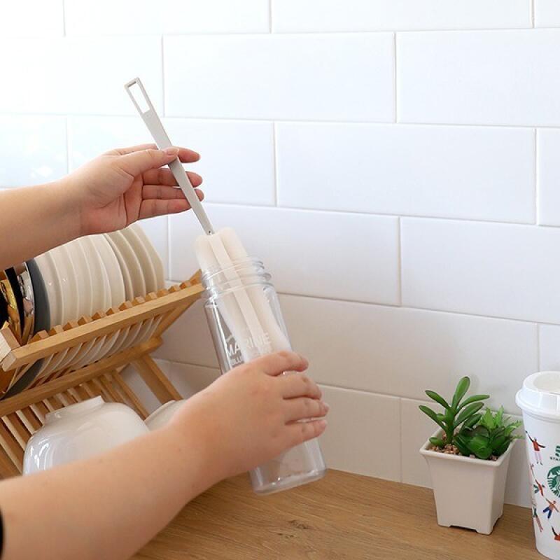 Water bottle, tumbler, small glass bottle, kitchen sponge, bottle brush