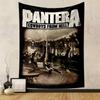 Band members performing energetically in a rustic indoor setting. Patterned tapestry for bedroom and living room home decor