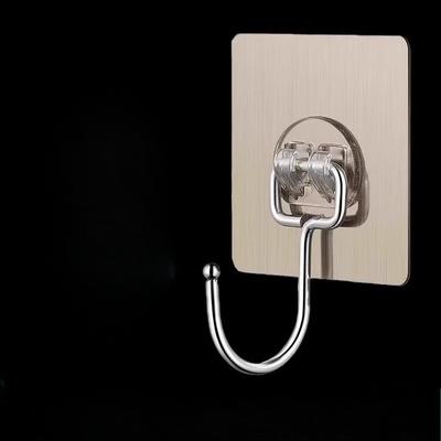 A Transparent Adhesive Wall-mounted Hook Without Drilling or Leaving Any Marks Is Pasted On The Wall Behind The Kitchen Door