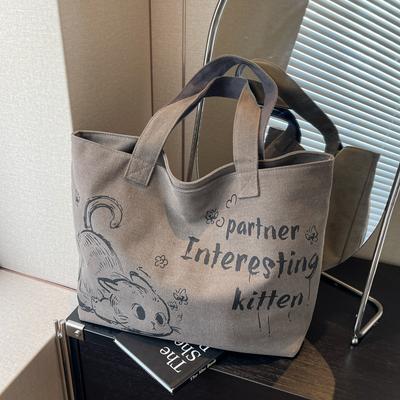 Borsa di tela con lettera di gatto dei cartoni animati da donna autunno e inverno 2025 nuova borsa a spalla di grande capacità borsa tote versatile
