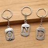 Pendentif Porte-clés 26 Lettres en Acier Inoxydable Creux - Polyvalent pour Sac à Dos, Voiture, Plaque Militaire
