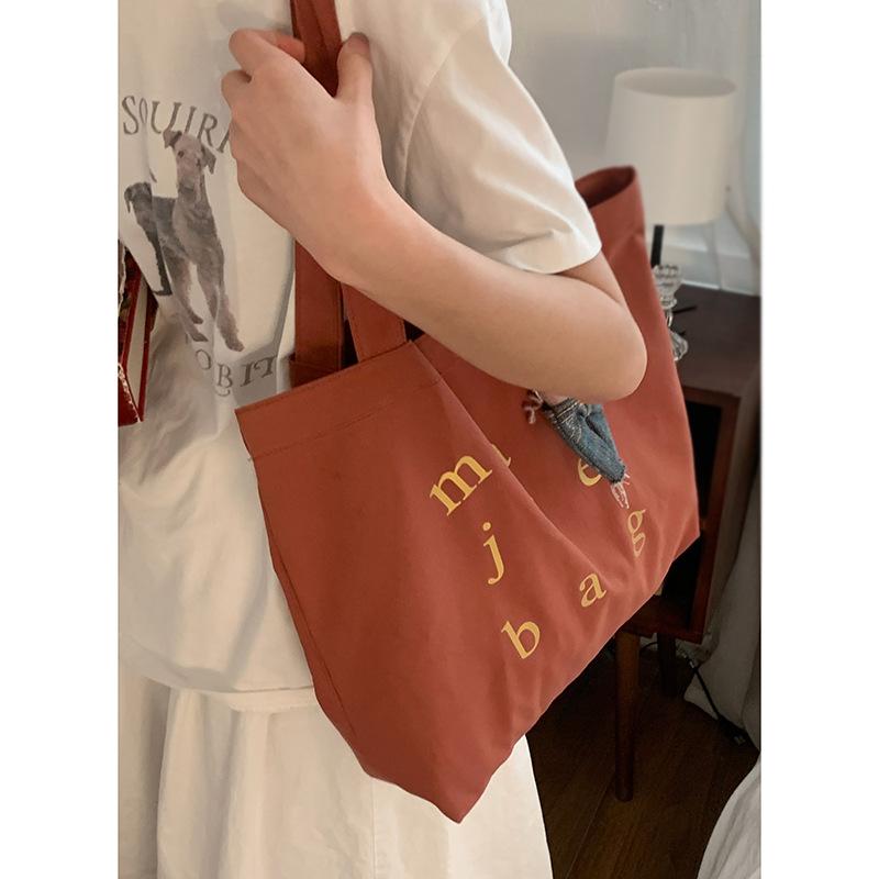 

Korean version of casual large-capacity underarm bag women s 2025 new simple letter print tote bag versatile shoulder bag brick червоний колір