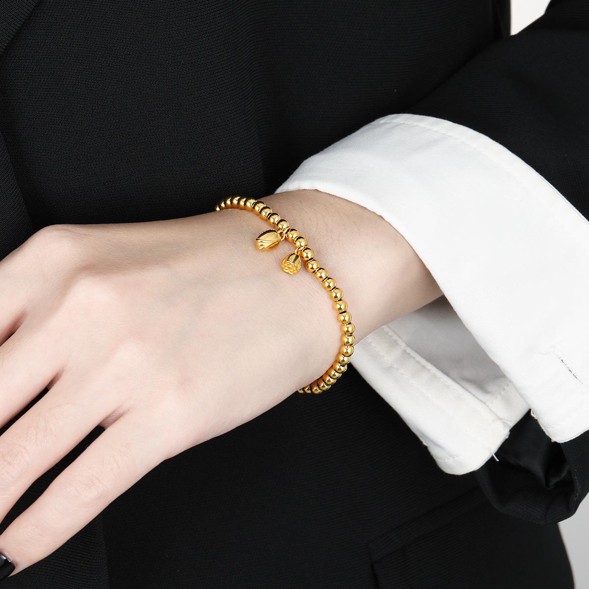 

Браслет из титановой стали Lotus: Древние семена лотоса и бусины из 24-каратного золота, эластичный дизайн, не выцветающий.