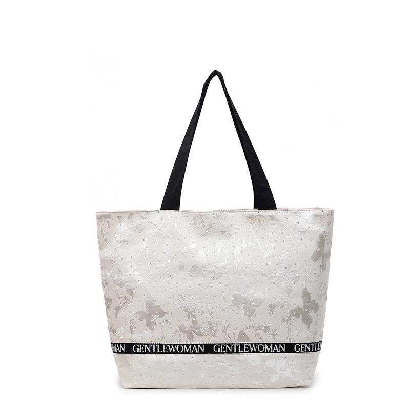 

Happy woman letter printing large capacity foreign style tote bag 2025 new sequined texture shoulder commuter women s bag 44*32*11