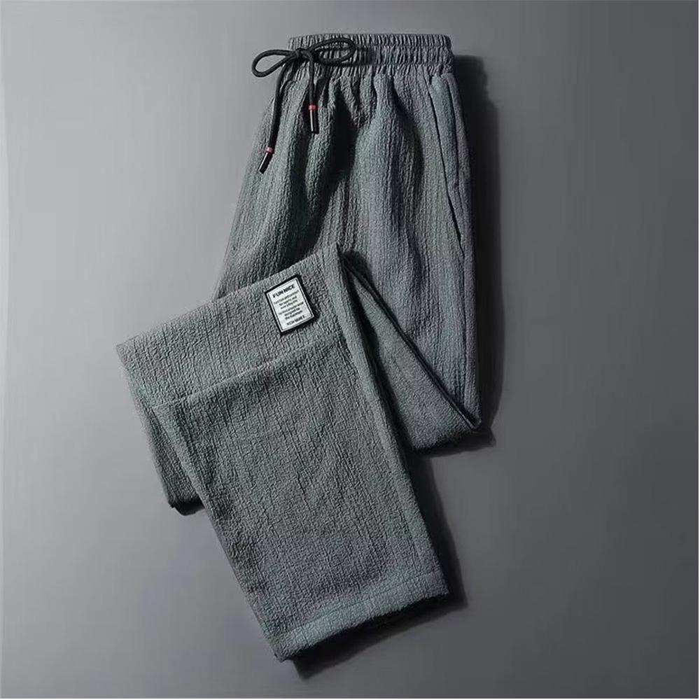 Męskie spodnie casualowe ze ściągaczem w pasie i modnym wzorem Harlan Pants Sportowe luźne spodnie w jednolitym kolorze