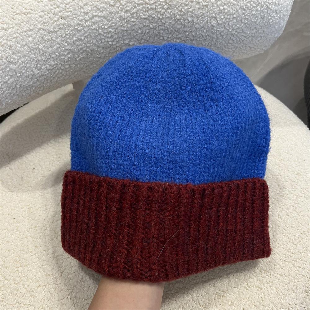 Simple two-color splicing wool hat women's autumn and winter warm niche versatile ear protection hat large version knitted pullover hat tide