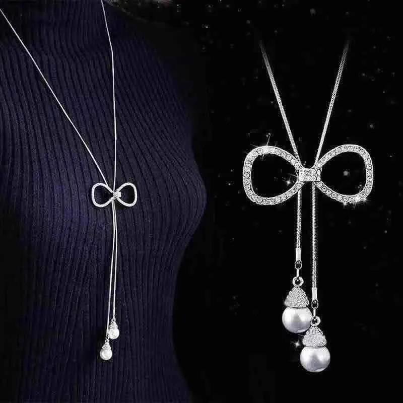 

Длинное ожерелье со стразами и кисточками в виде свитера