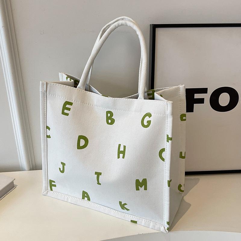 

Холщовая сумка большой вместимости женская 2025 новая модная и стильная сумка-тоут для通勤 женская зарубежная универсальная наплечная сумка a белый