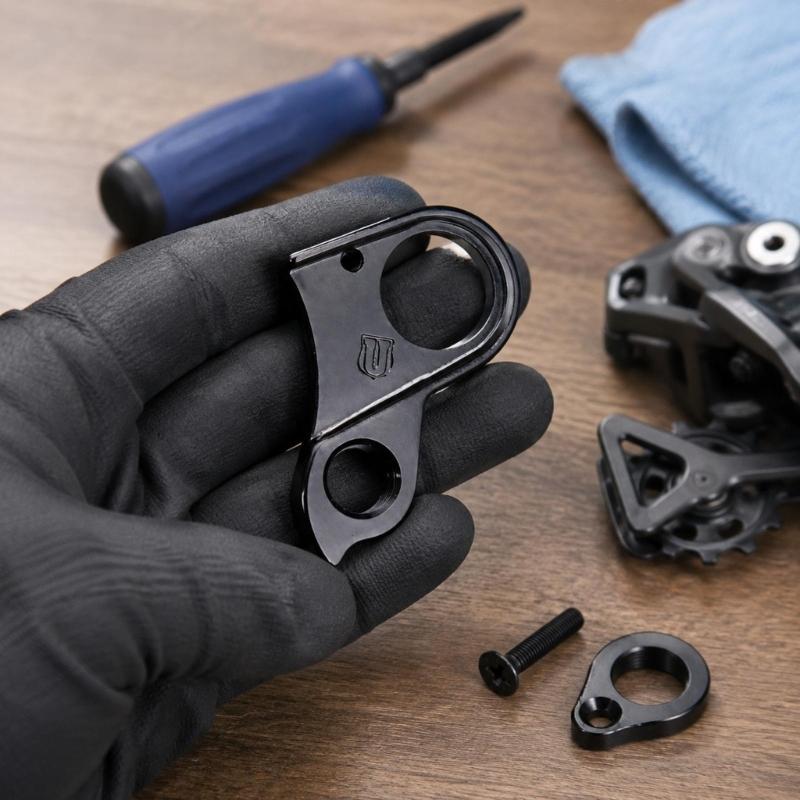 Machined Aluminum Rear Shifting Hanger, Part 10240 H695 with Frame Opening, Bushing Connection, Screw Mounting Point, and Included Screw