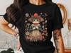 Cottagecore Cat T-Shirt, Whimsical Mushroom Cat Art Tee, Vintage Floral Cat Lover Shirt, Cute Feline In Red Hat Graphic Tee