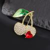 Huaqianguhh Brooch Pin, Cherry Heart Shape Lapel Pin with Green Leaves, Sparkling Rhinestones Enamel Decorative Badge for Coats Suits Bags