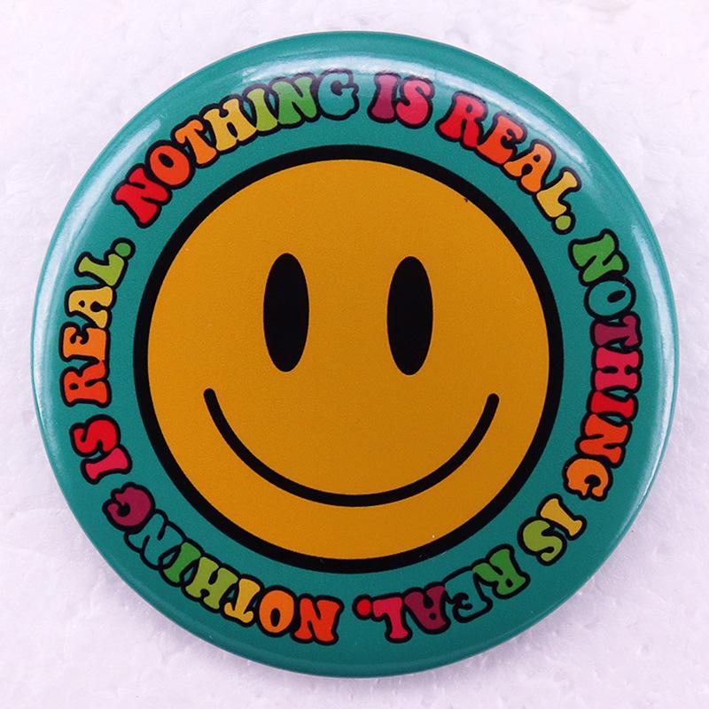 Yellow Smiley Face Tinplate Badge:  Nothing is Real  Brooch