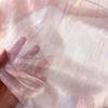 Drapeable semi-transparent pink lustrous gold-textured fabric suitable for wedding dresses formal gown designer clothing fabrics
