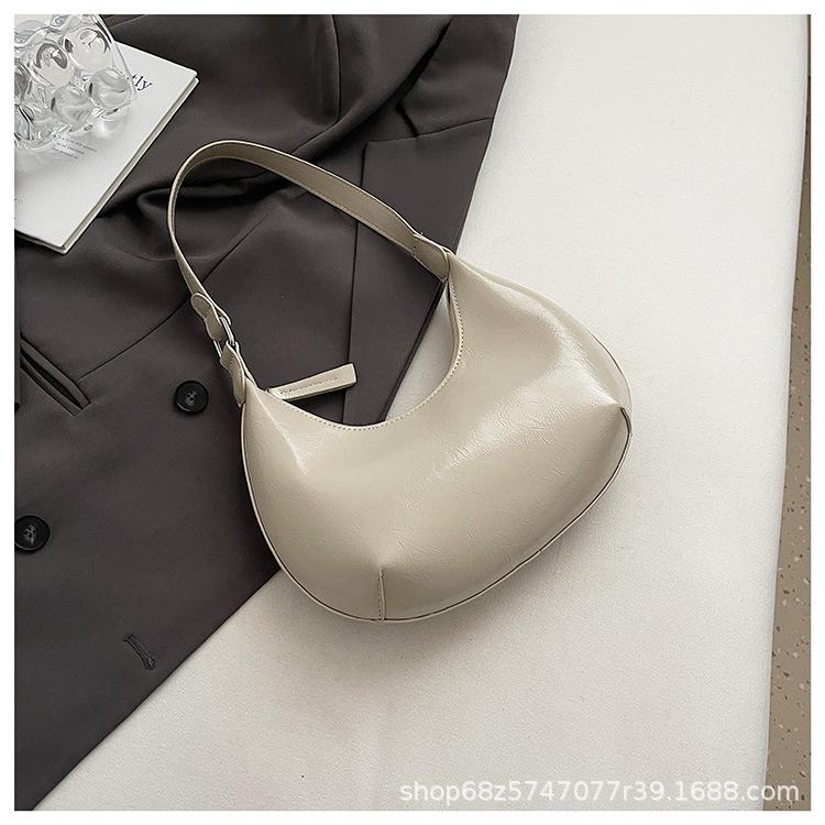 Small bag trend 2025 new fashion handbag high sense versatile women's bag single shoulder solid color half moon armpit bag