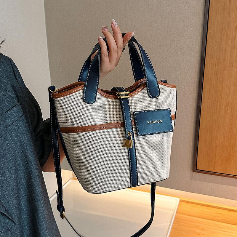 Canvas niche contrasting color handbag women's 2025 summer new Korean fashion shoulder messenger bag versatile bucket bag
