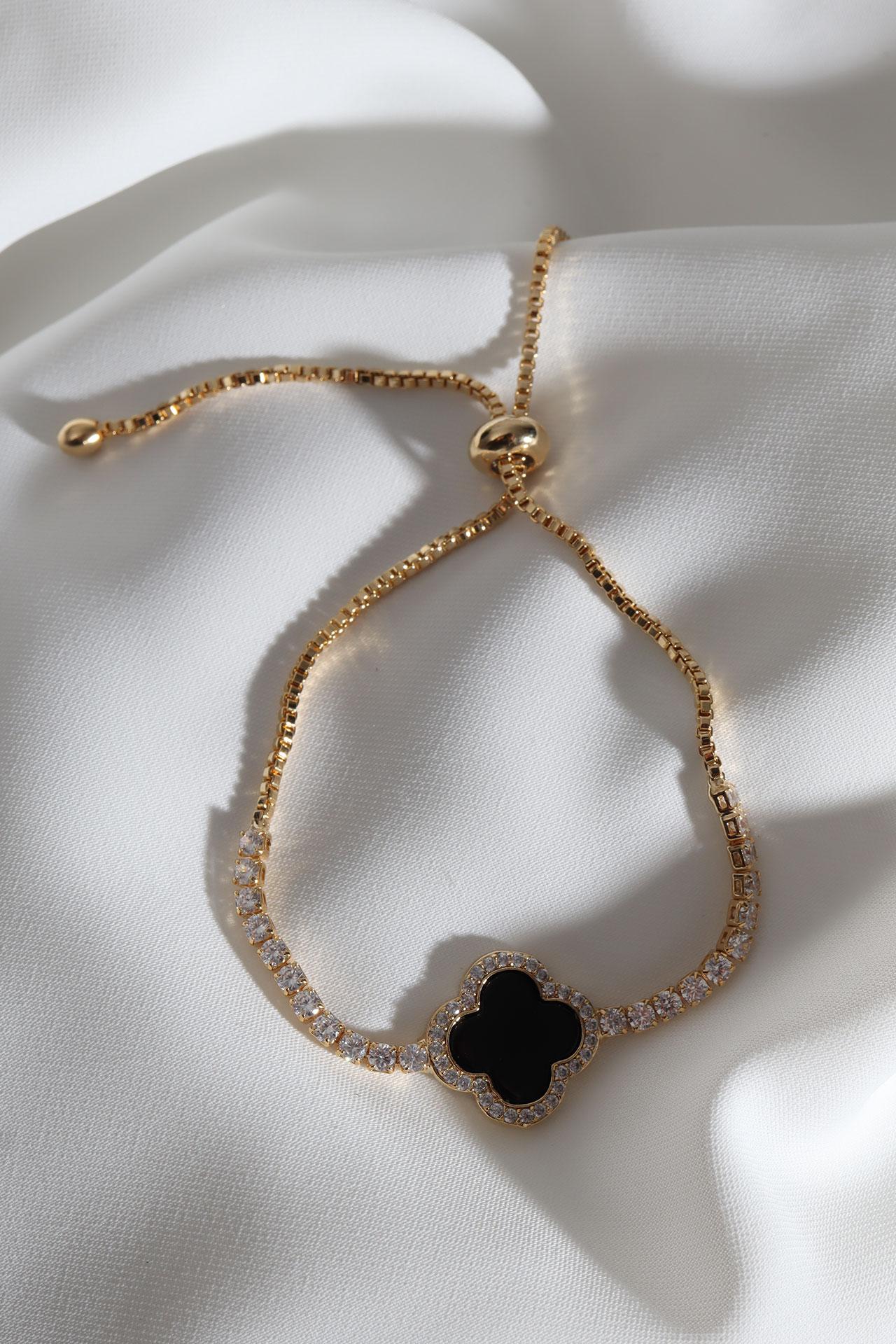 

Браслет золотого цвета с черным эмалированным клеверным лифтом