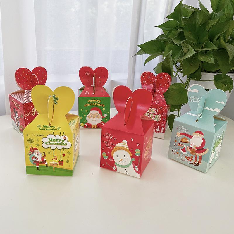 

Сложенная вручную рождественская подарочная коробка с яблоками