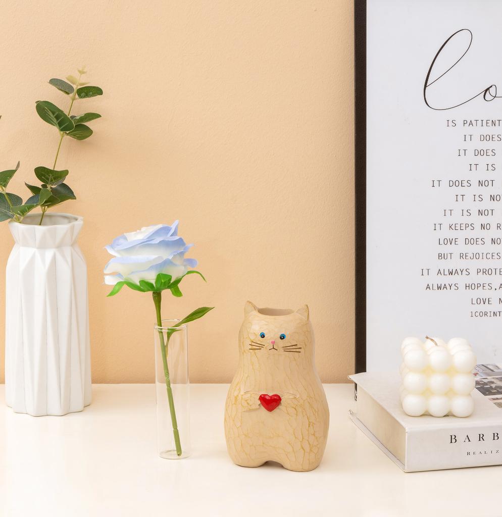A cat shaped storage pen holder with heart-shaped decorative statues and multifunctional vase decorations