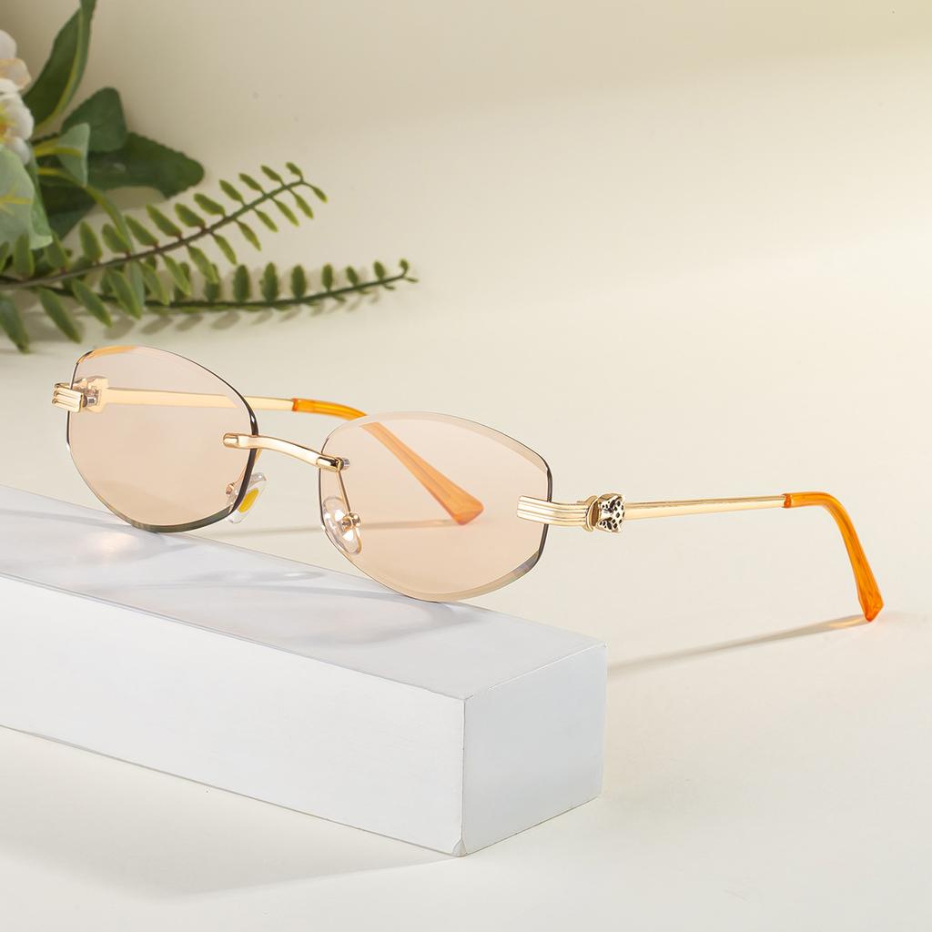 New European and American fashion oval frameless color-changing sunglasses female leopard head metal temple UV sunscreen sunglasses